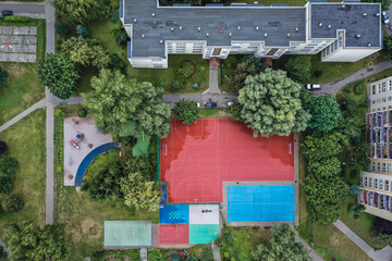 Fototapeta na wymiar Higha angle drone view of playground and sports fields in Goclaw housing estate, part of South Praga district of Warsaw, capital of Poland