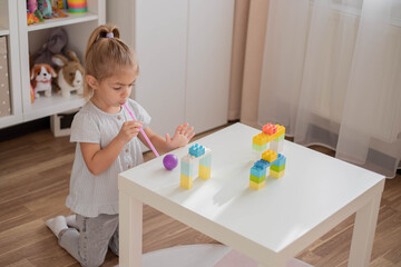 Great activity for building oral motor skills at home. Child playing with straw and pipe pong ball. Activities for  preschooler.