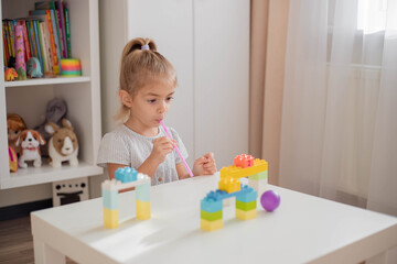 Great activity for building oral motor skills at home. Child playing with straw and pipe pong ball. Activities for  preschooler.