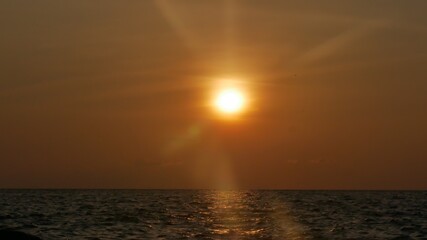 Bright illumination sunrise over the sea.