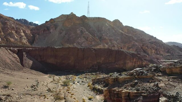 Cellular antenna reveals at the top of a mountain in the desert.