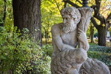 Fototapeta na wymiar Satyr - lamp sculpture in Lazienki - Royal Baths Park in Warsaw, capital city of Poland