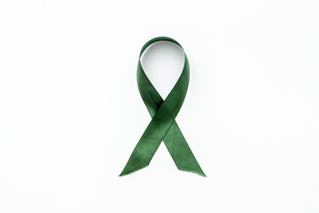 Green awareness ribbon isolated on a white background. Top view