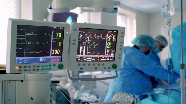 Mechanical ventilation equipment. Ventilation of the lungs with oxygen. Group of surgeons in operating room with surgery equipment.