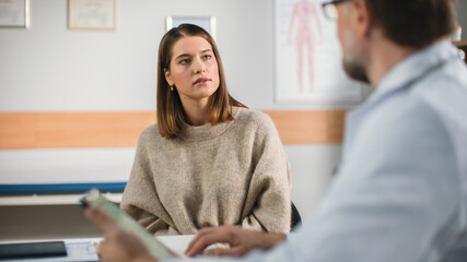 Doctor's Consultation Office: Professional Physician Talks to the Female Patient, Uses Digital Tablet Computer to Explain Test Results, Symptoms, Treatment Plan, Prescribes Medicine.