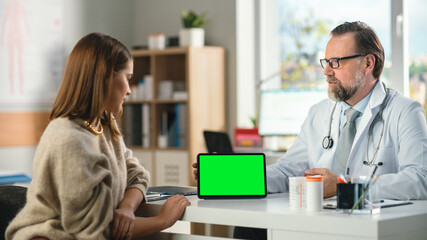 In a Doctor's Consultation Room: Professional Physician Uses Green Chroma Key Digital Tablet Computer in Horisontal Mode to Explain Test Results to a Female Patient and Prescribes Medicine.