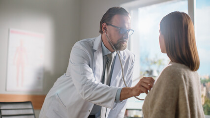 Obraz premium Doctor's Consultation Office: Physician Uses Stethoscope to Listen to Heartbeat and Lungs of the Female Patient. Medical Health Care Professionals Diagnosing, Treating Patient. Health Care Specialist.