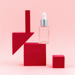 Cosmetic serum bottle on pink background. Beauty wellness natural concept. Pedestal product display creative concept. Geometric shape podiums clipart with copy space. Front view.