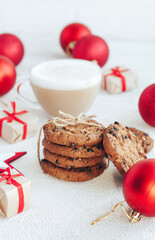 Cookie with chocolate and coffe on the white background. New Year's decorations and gift boxes surround them. - 393563840