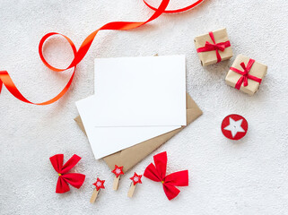 Beautiful red Christmas decorations with empty card and envelope on white background. Flat lay composition with copy space. - 393565434