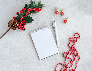 White blank notepad for wish list and Christmas red decor on gray background. - 393565474