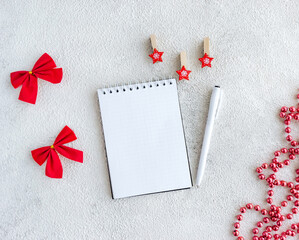 White blank notepad for wish list and Christmas red decor on gray background. - 393565483