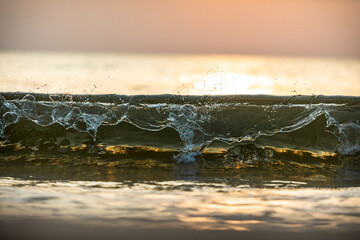 Golden hour on a seaside small waves 