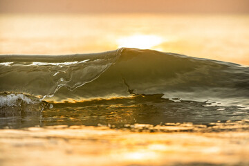 Golden hour on a seaside small waves 