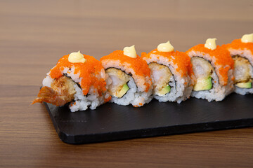 California roll with salmon, avocado, cucumber, crab and flying fish egg.