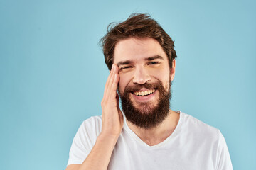 Cheerful man gesturing with his hands emotions cropped view on blue background studio