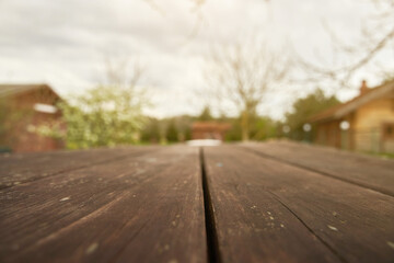 wooden table surface with blurred garden view