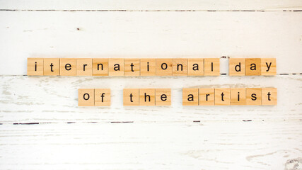 international day of the artist.words from wooden cubes with letters photo