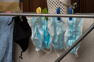 Closeup of medical masks on hanger after washing for recycling during the covid-19 pandemic