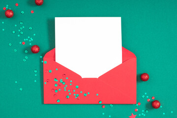 Christmas creative composition. Xmas decorations, envelopes on green background. Christmas, New Year, winter concept. Flat lay, top view, copy space