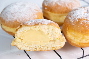 Close-up of donuts , Berlin pancakes, dusted with powdered sugar served on a rustic wooden table