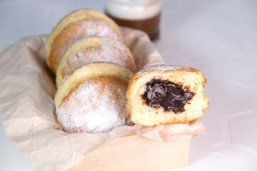 Close-up of donuts , Berlin pancakes, dusted with powdered sugar served on a rustic wooden table