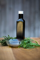 Hemp, with a teacup with hemp tea. It natural ambience that emphasizes the organic character of hemp. A black bottle with hemp oil is also seen. 