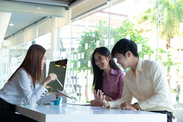 Cropped shot of two UI developers meeting on their project with paperwork and tablet on meeting...