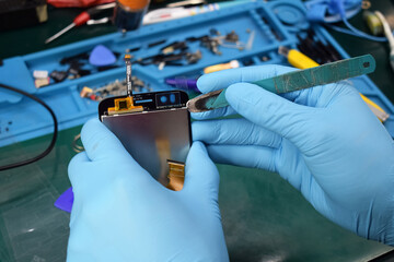 technician is fixing the mobile LCD display.