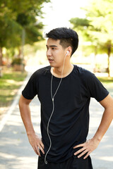 A young man walks outdoor as workout