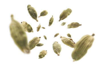 Cardamom pods levitate on a white background