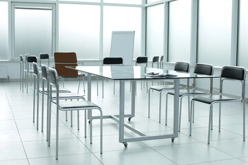 Black chairs glass table motebook in office space