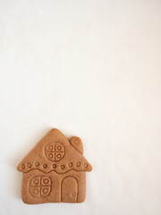 House-shaped gingerbread cookie on white background
