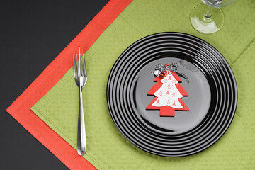 Black plate and christmas decoration for holiday menu