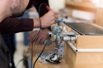 Scientists engineers designing small human robot, setting artificial intelligence humanoid robot. Artificial intelligence, futuristic and smart robots concept.