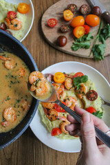 Pouring shrimps with garlic sauce over mashed potatoes plate. Plating spring dish. Beautiful food. Slow life. Slow cooking, 