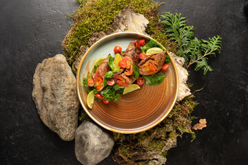 Bacon and stewed vegetable rolls with basil, lime and cherry tomatoes. A hot dish of meat and vegetables.