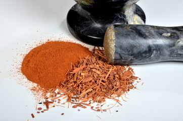 Catuaba bark and catuaba powder on white background. Natural herbal tea from Catuaba tree bark,...