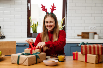 Happy young girl wearing pajamas celebrating christmas