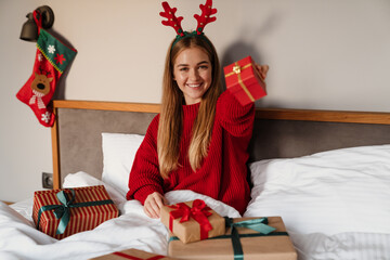 Fototapeta premium Happy young girl wearing red pajamas