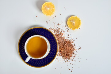 Cup of tea, Catuaba bark and lemon on white background. Natural herbal tea from Catuaba tree bark,...