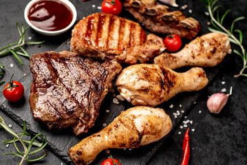 Various types of grilled meat, beef, pork, chicken on stone background	