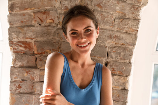 Young happy brunette woman smiling and looking at camera