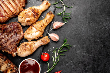 Various types of grilled meat, beef, pork, chicken on stone background	with copy space	