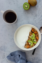 Muesli with white yogurt, kiwi and coconut. Granola. Healthy eating. Vegetarian food. Breakfast.