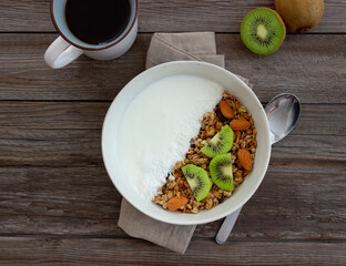 Muesli with white yogurt, kiwi and coconut. Granola. Healthy eating. Vegetarian food. Breakfast.
