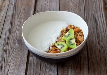 Muesli with white yogurt, kiwi and coconut. Granola. Healthy eating. Vegetarian food. Breakfast.