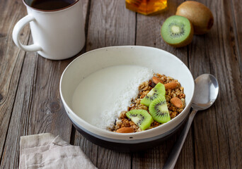 Muesli with white yogurt, kiwi and coconut. Granola. Healthy eating. Vegetarian food. Breakfast.