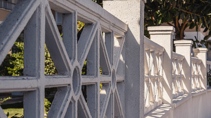 concrete white ornamental square lattice fence on the street