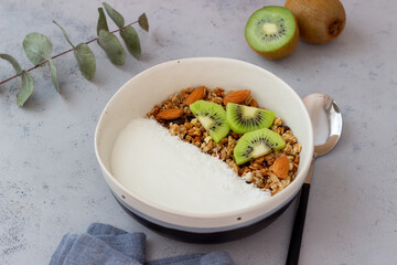 Muesli with white yogurt, kiwi and coconut. Granola. Healthy eating. Vegetarian food. Breakfast.
